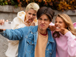 guy takes selfie with friends