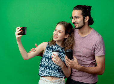 People on a green background taking selfies
